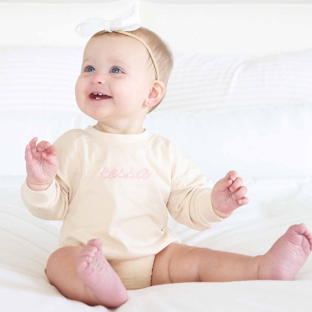 embroidered name romper long sleeve natural tan with light pink thread 