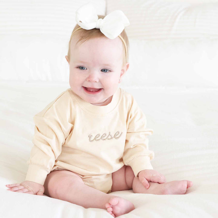 embroidered name romper for babies with natural tan thread
