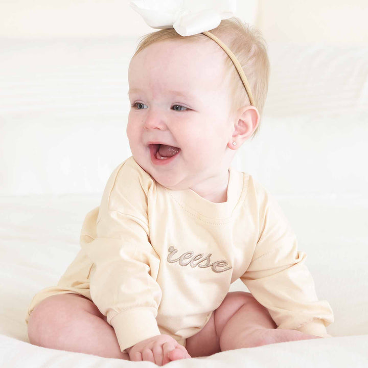 name embroidered romper with tan thread 