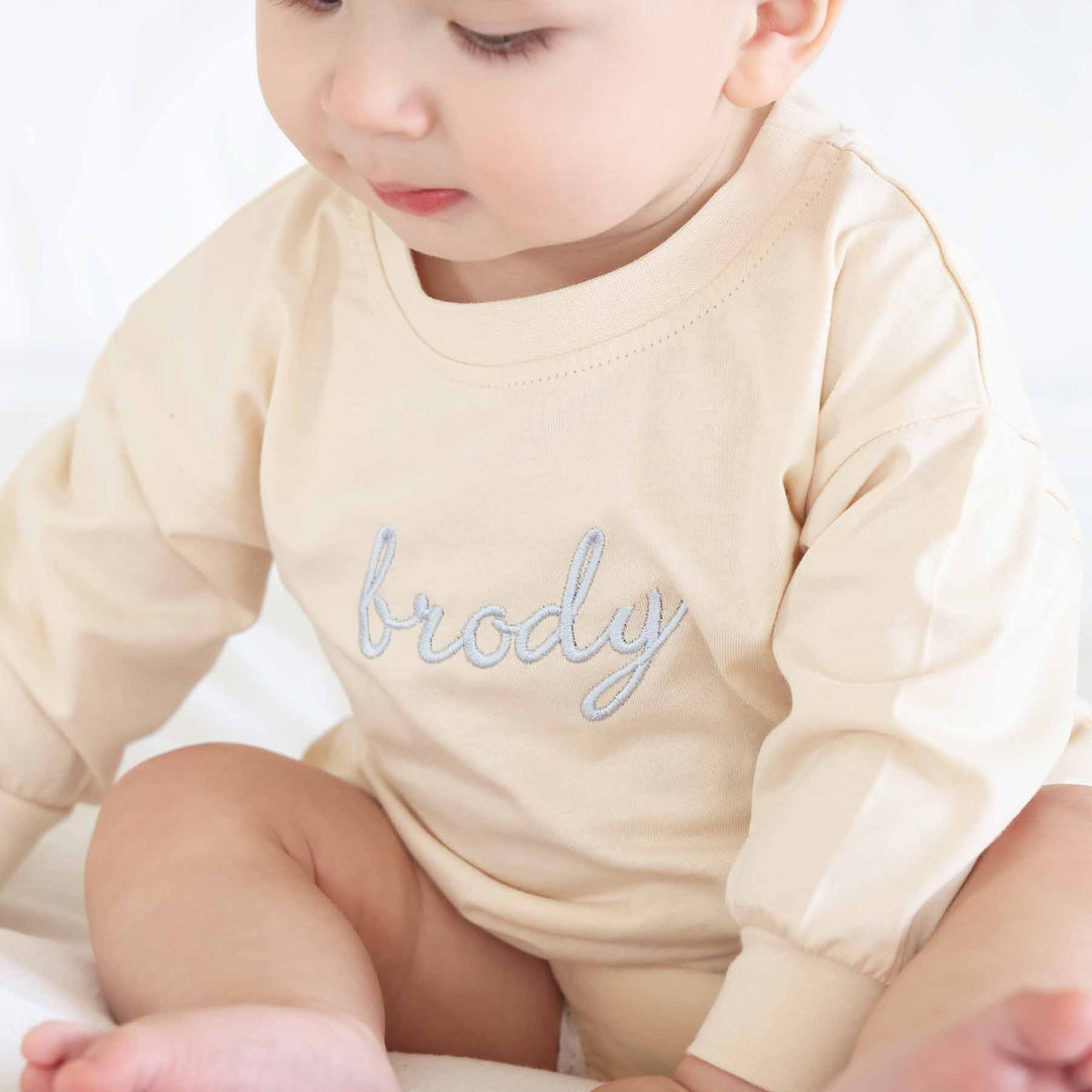 natural color embroidered name bubble romper with blue thread 