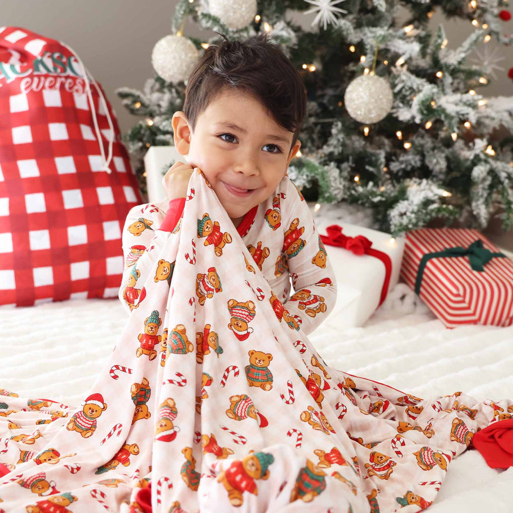 neutral gingham bamboo blanket for kids with teddy bears dressed in christmas sweaters 