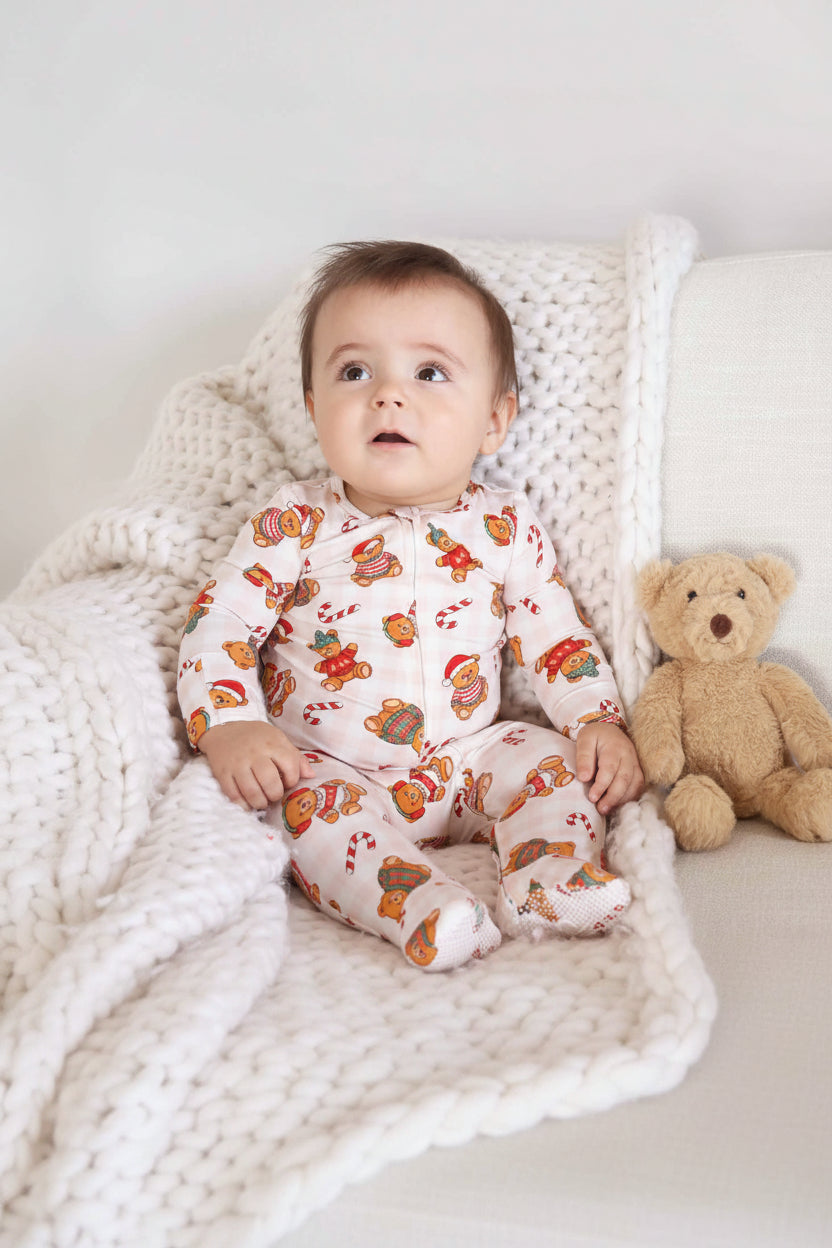 candy cane and christmas teddy bear zipper footie for baby boys with a neutral gingham background 