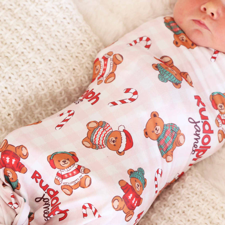 personalized newborn swaddle with teddy bears dressed in christmas sweaters with candy canes 