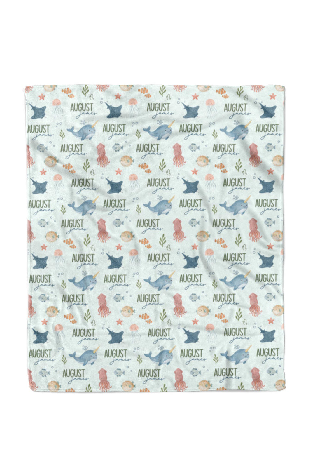 Flat lay of a fully unfolded personalized Caden Lane Ocean Dreams blanket in seafoam, showing the full repeating pattern of sea creatures and custom name