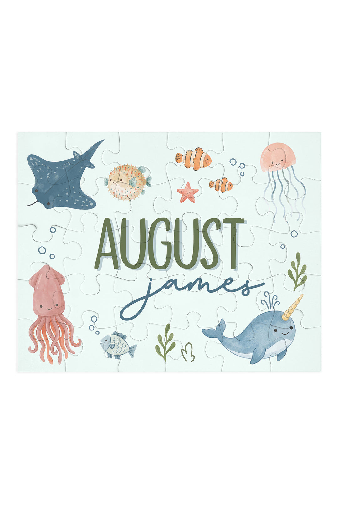 Flat lay of an assembled personalized Caden Lane Ocean Dreams jigsaw puzzle in seafoam, showing sea creatures and custom name
