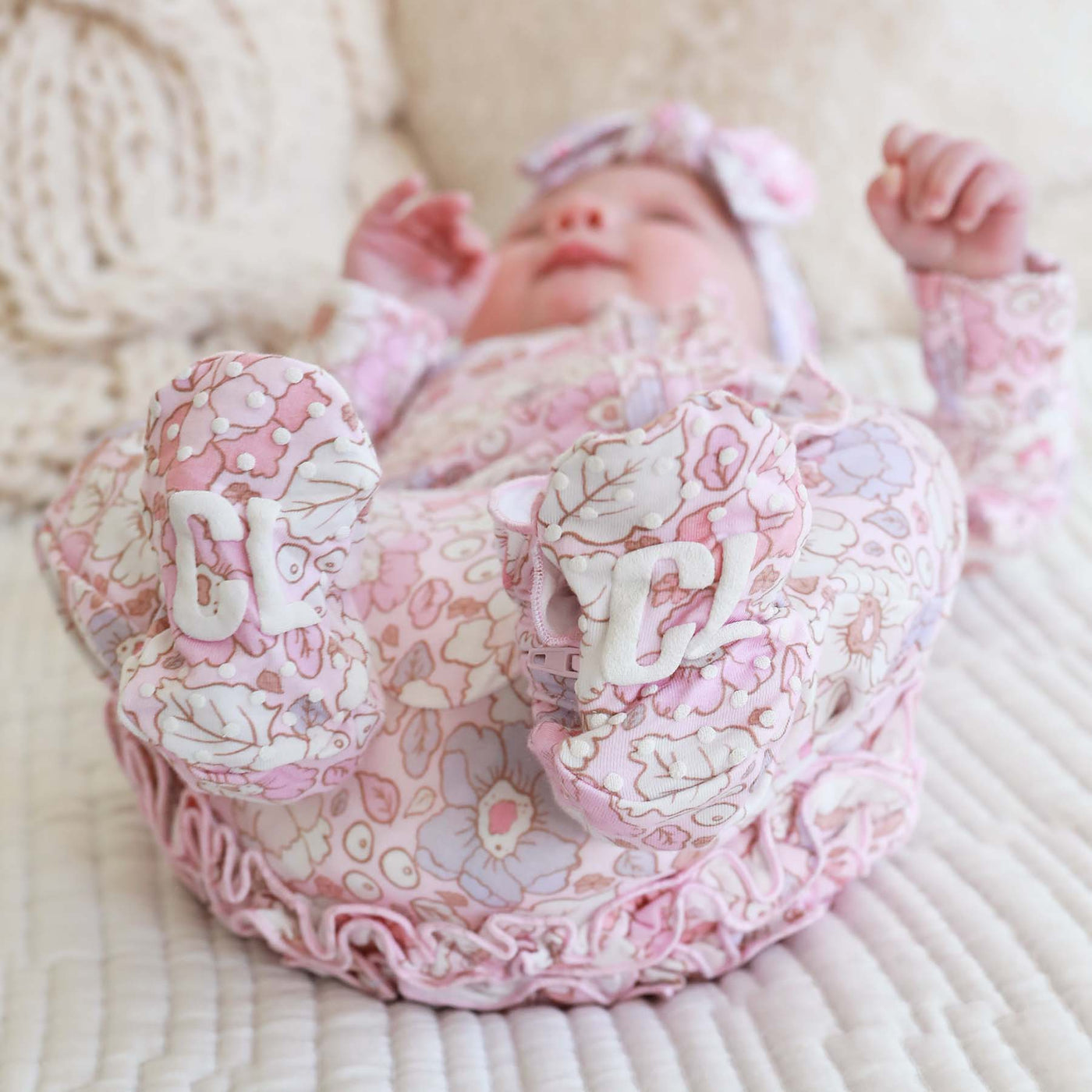 pink and purple floral baby footie with ruffles