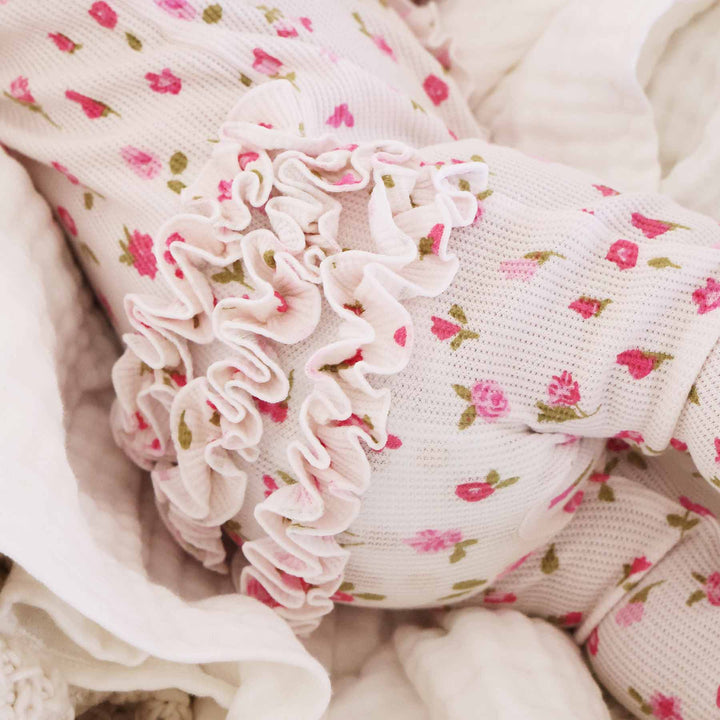 pink and white flower baby footie