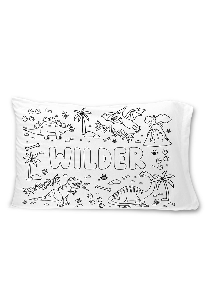 Caden Lane colorable pillowcase with the name "Wilder" surrounded by dinosaurs, a volcano, palm trees, and "Rawr!" sound effect text.