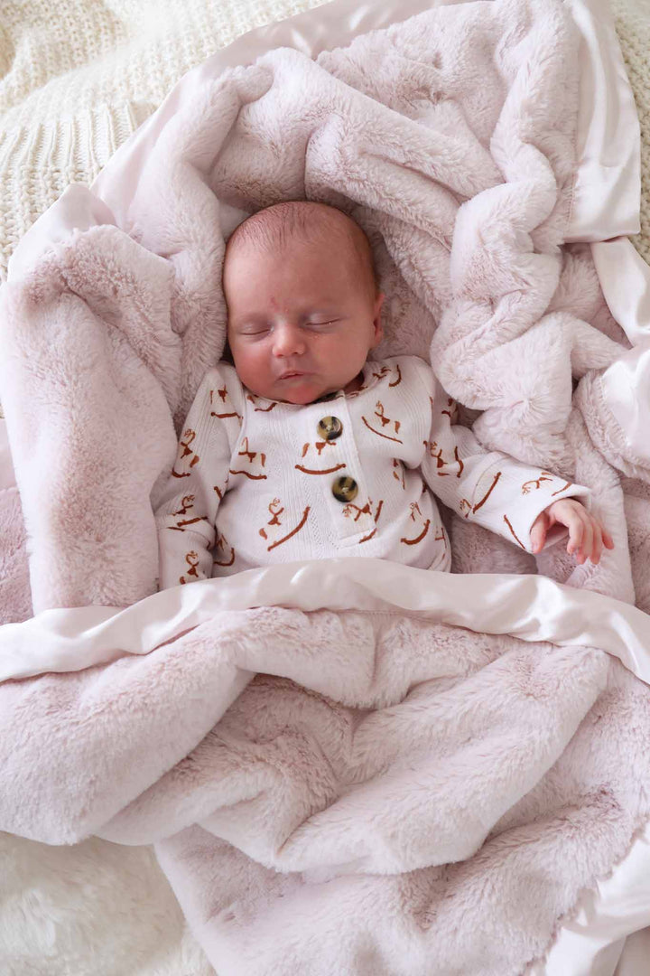 baby in rocking horse 2pc set with a pink blanket around him