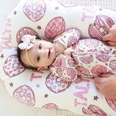 baby zipper footie with pink donuts and ruffles 