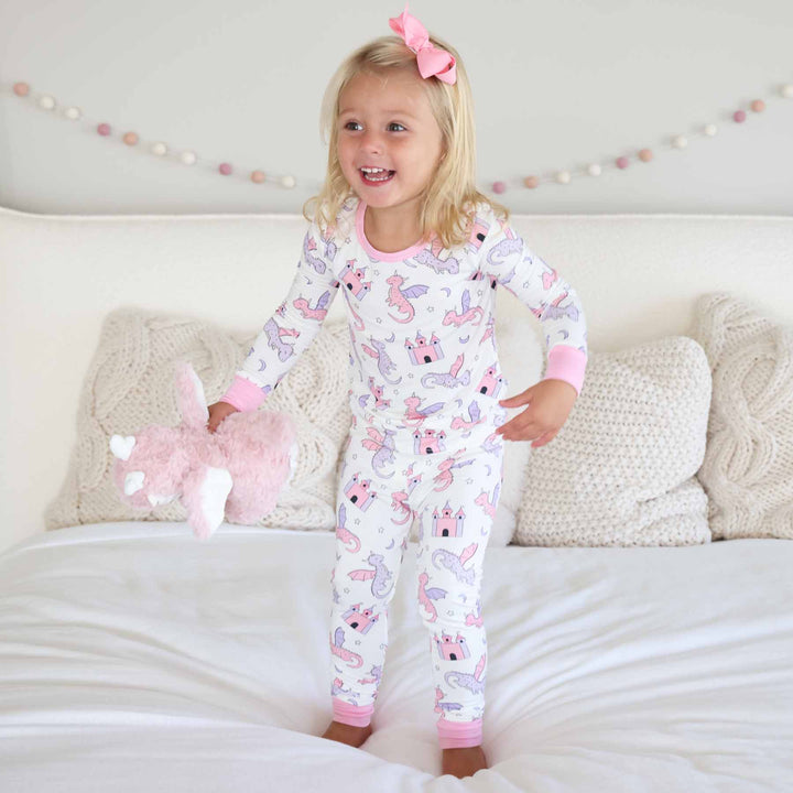 long sleeve and pants two piece pajama set for girls with pink dragon stuffed animal 