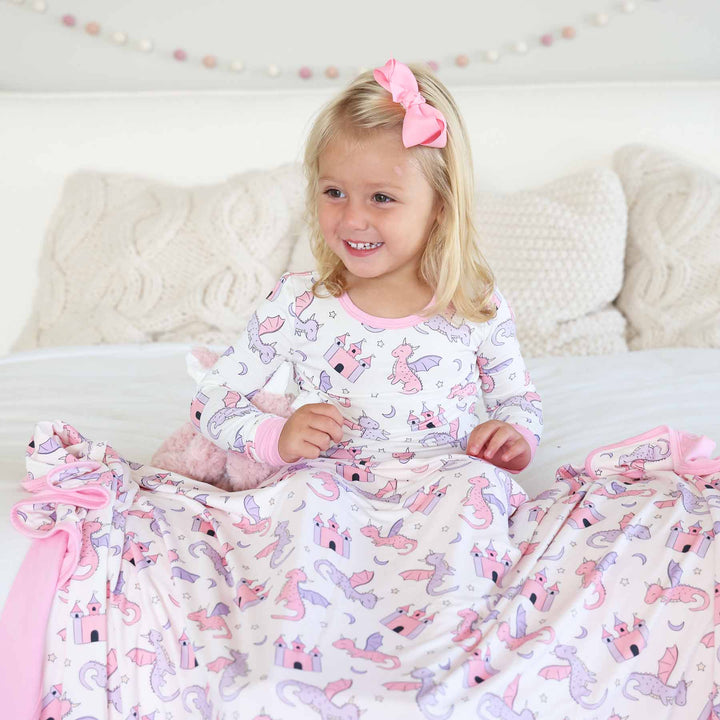 girls wearing pink dragon adventure two piece pajama set with matching bamboo blanket 