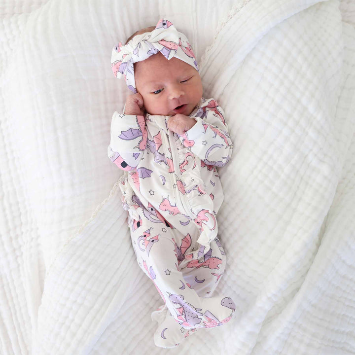 fairytale themed ruffle zipper footie on a baby girl with a matching headwrap