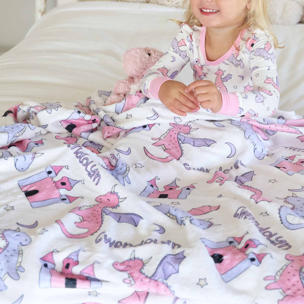 personalized blanket for kids with pink and purple dragons, castles, stars and moons