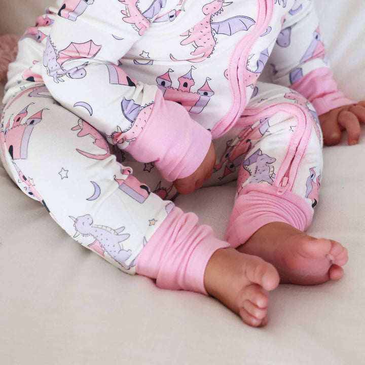 pink trim dragon adventure dragon and castle zip romper pajama for baby and toddler girls 