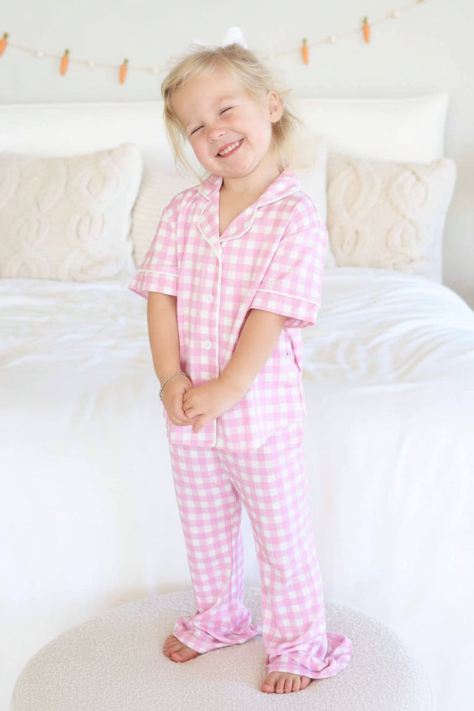 girl standing on ottoman in pink gingham easter lounge set 