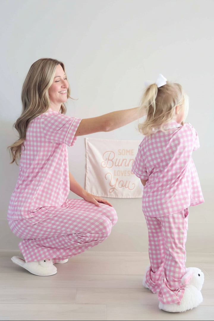 mom and daughter wearing pink matching gingham lounge sets for easter with bunny slippers 
