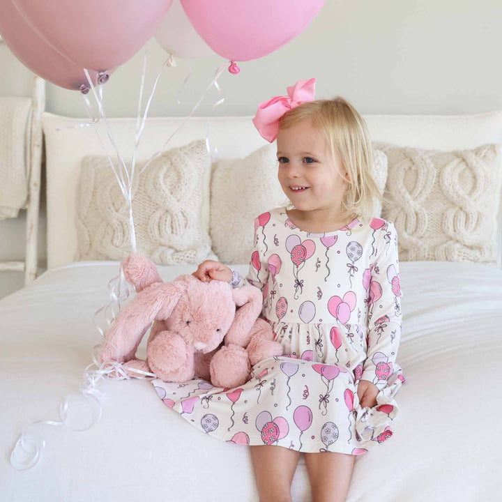 long sleeve pink party time knee length dress for girls with matching pink ribbon bow