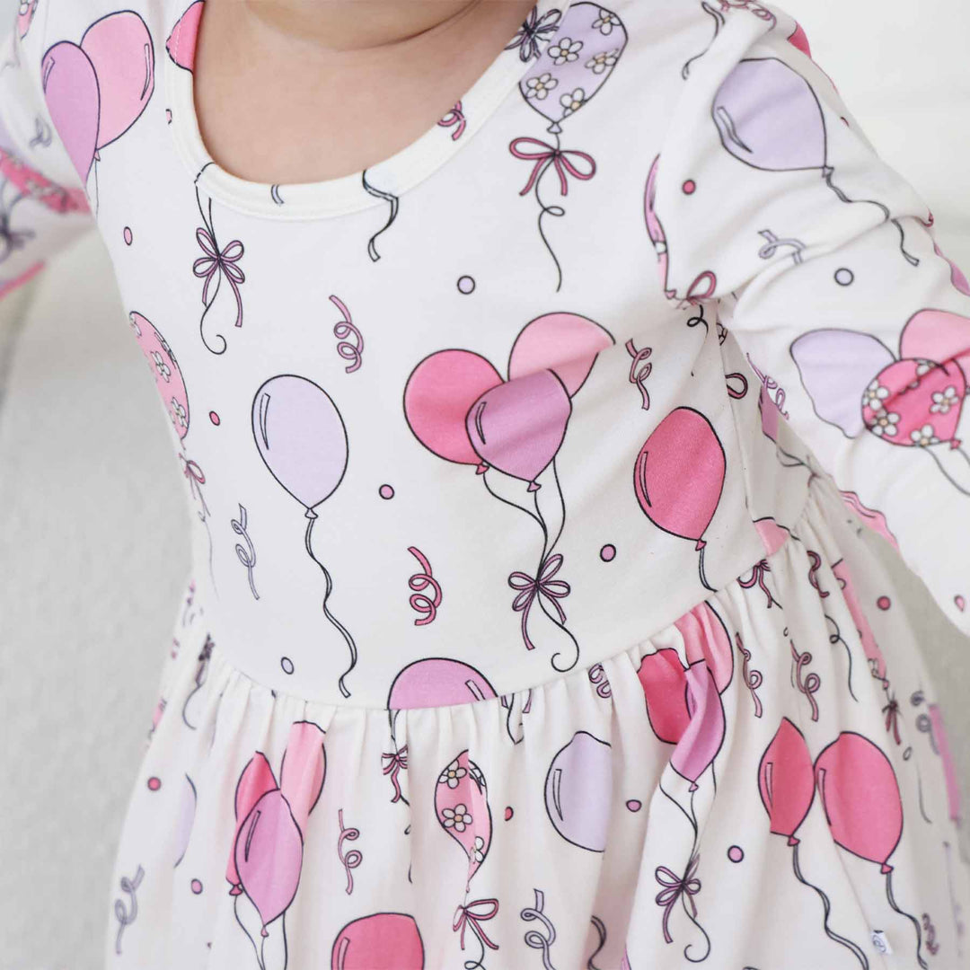 pink, purple and white skirt bodysuit for girls with balloons 