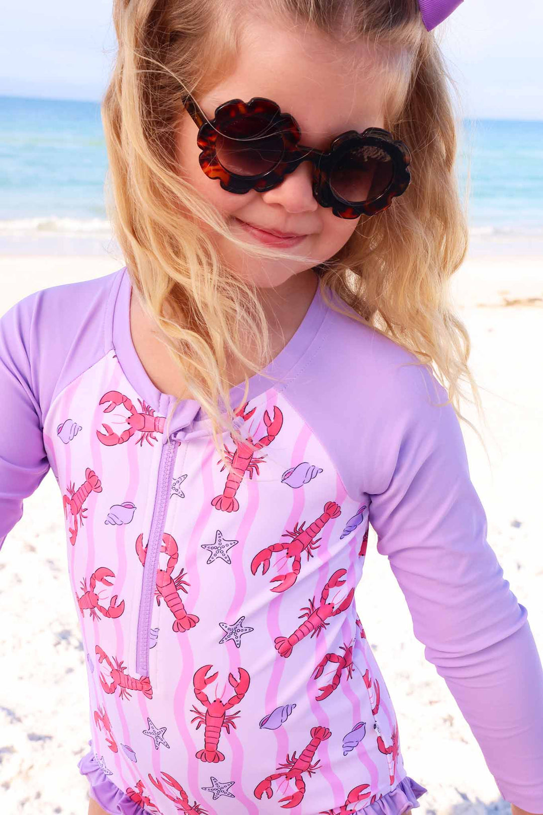 closeup of pink me lobster long sleeve rash guard swimsuit with front zipper for girls 