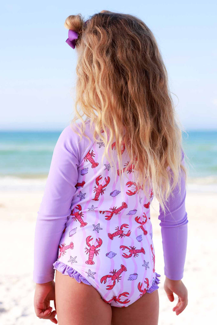 back view of pink and purple lobster striped rash guard swimsuit for girls 