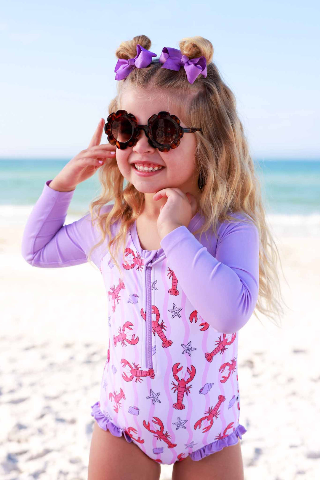 pinch me pink long sleeve rash guard swimsuit with front zipper with tortoise shell flower shaped sunglasses 