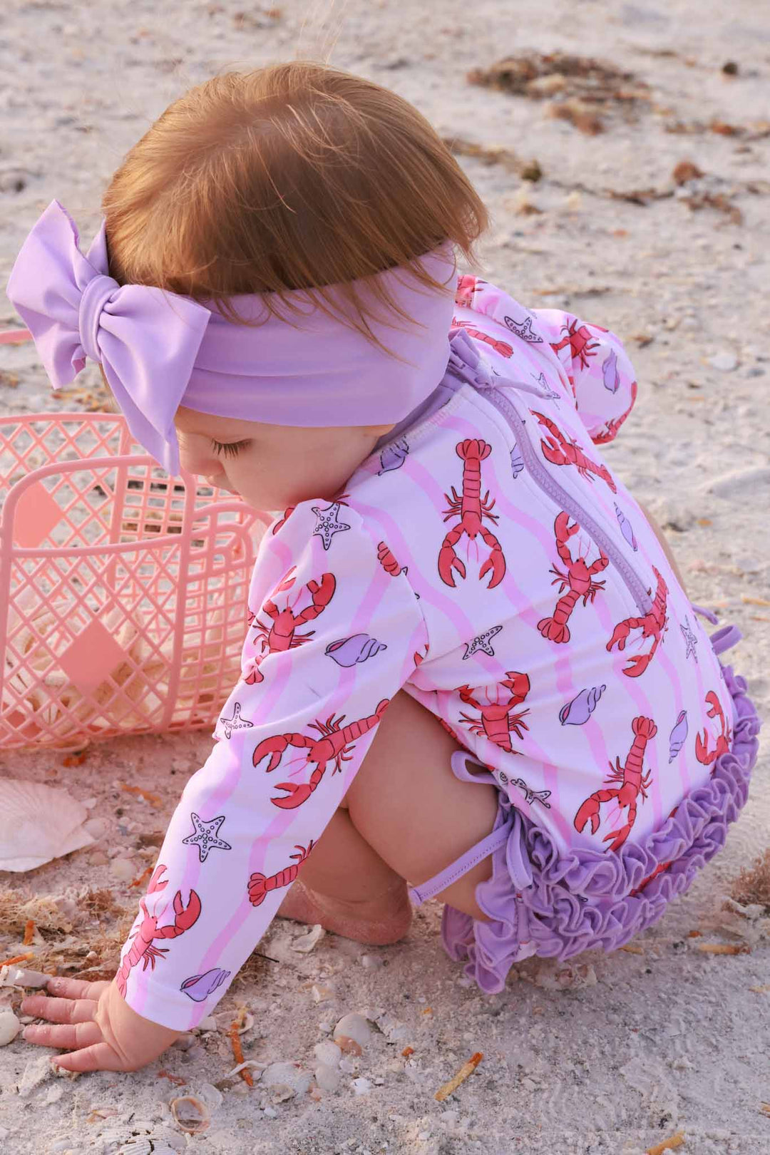 pinch me pink and purple ruffle bottom swimsuit with a matching purple swim bow