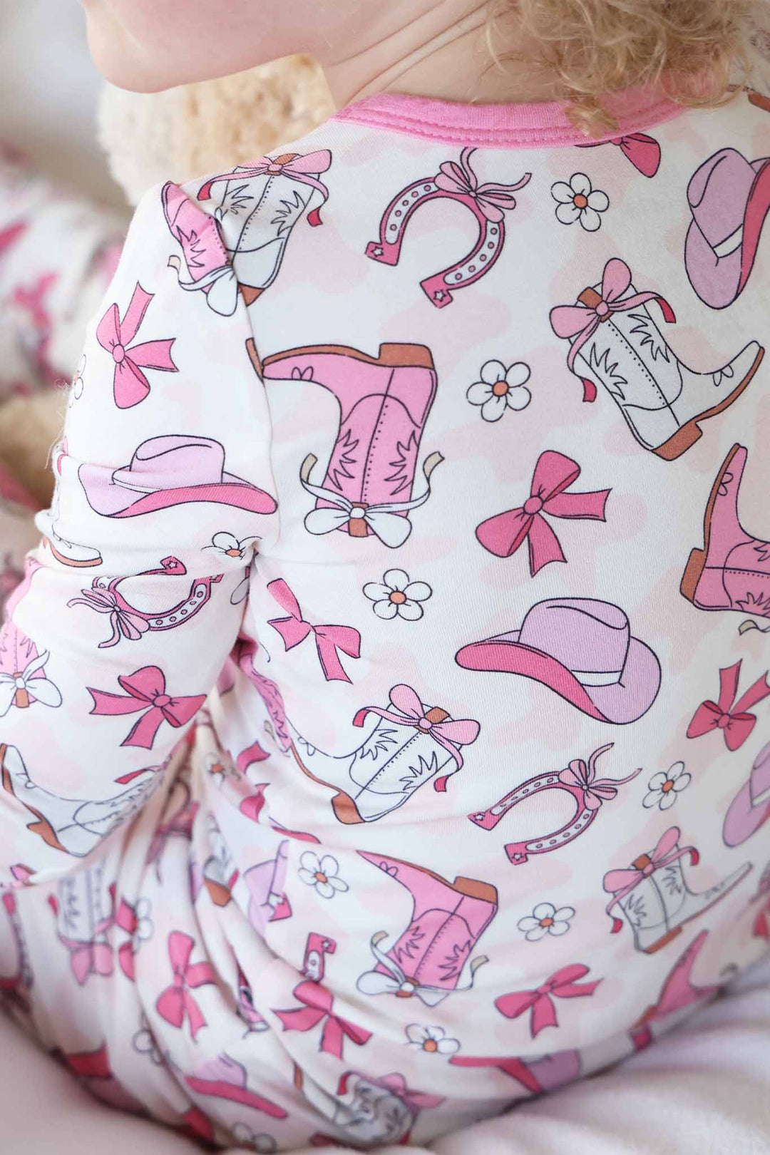 pink rodeo dreams pajama print with cowgirl boots, hats, horseshoes, bows and daisies 