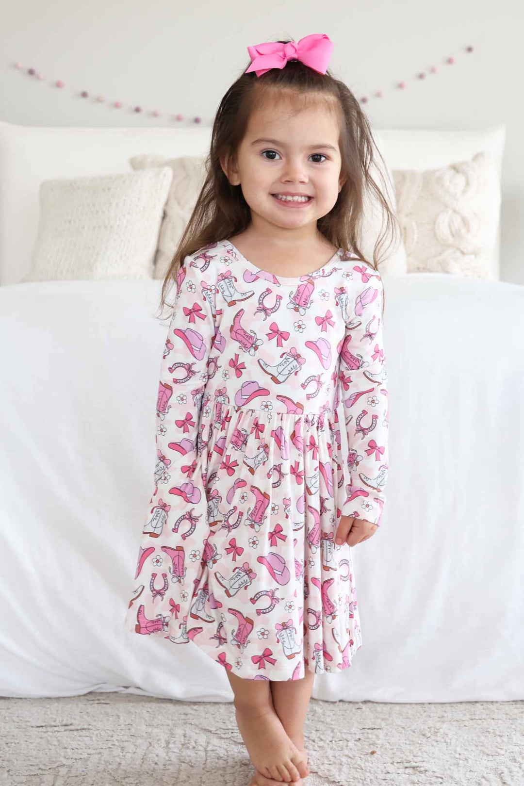 pink long sleeve casual dress for girls with pink rodeo dreams print with a matching ribbon bow 