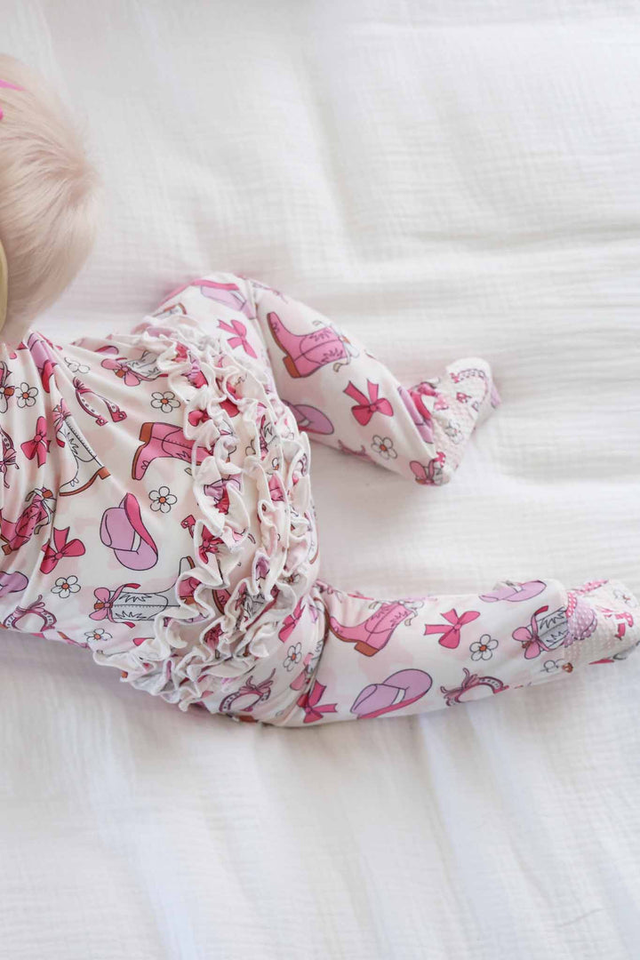 view of back of pink rodeo dreams ruffle footie pajama for baby girls 