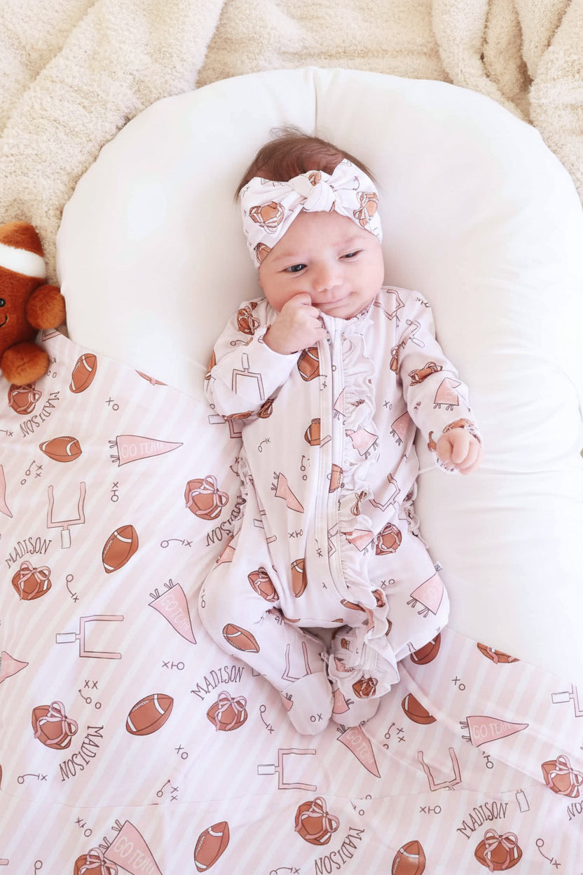 Tiny Touchdowns Ruffle Zipper Footie in Pink | Caden Lane