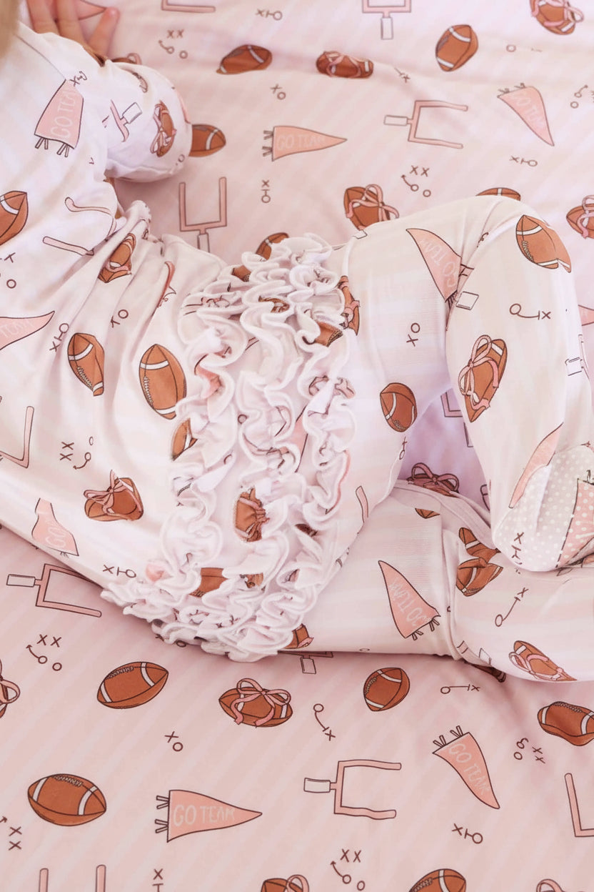 Tiny Touchdowns Ruffle Zipper Footie in Pink | Caden Lane