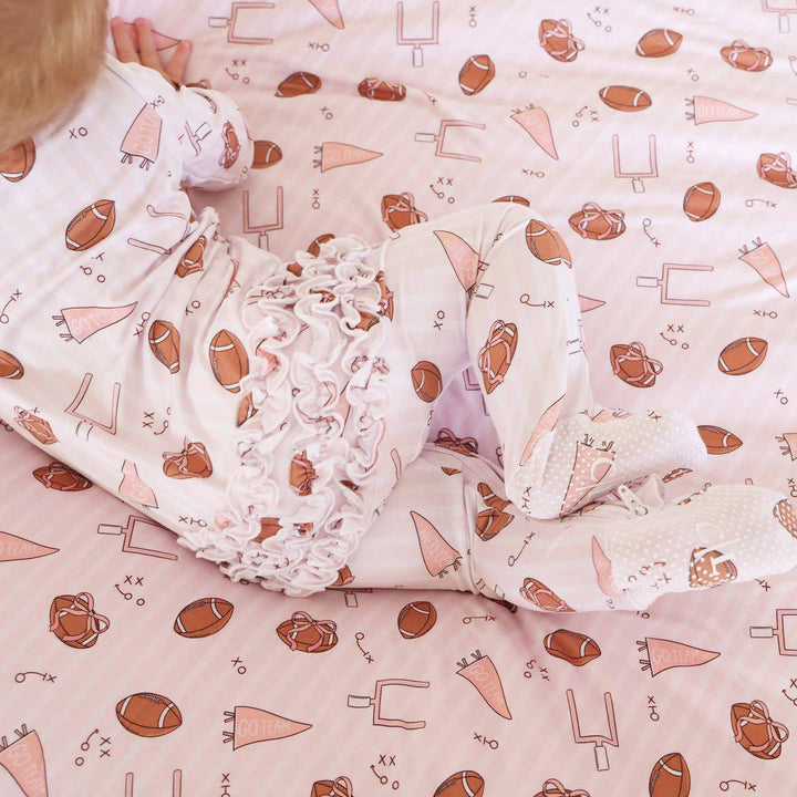 back of pink tiny touchdown ruffle footie 