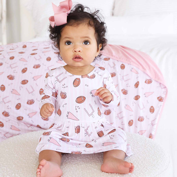 pink tiny touchdowns long sleeve twirl bodysuit for babies