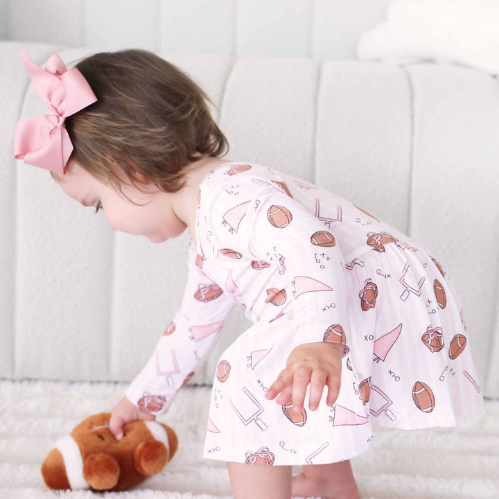 pink tiny touchdowns long sleeve twirl bodysuit for baby and toddler girls 