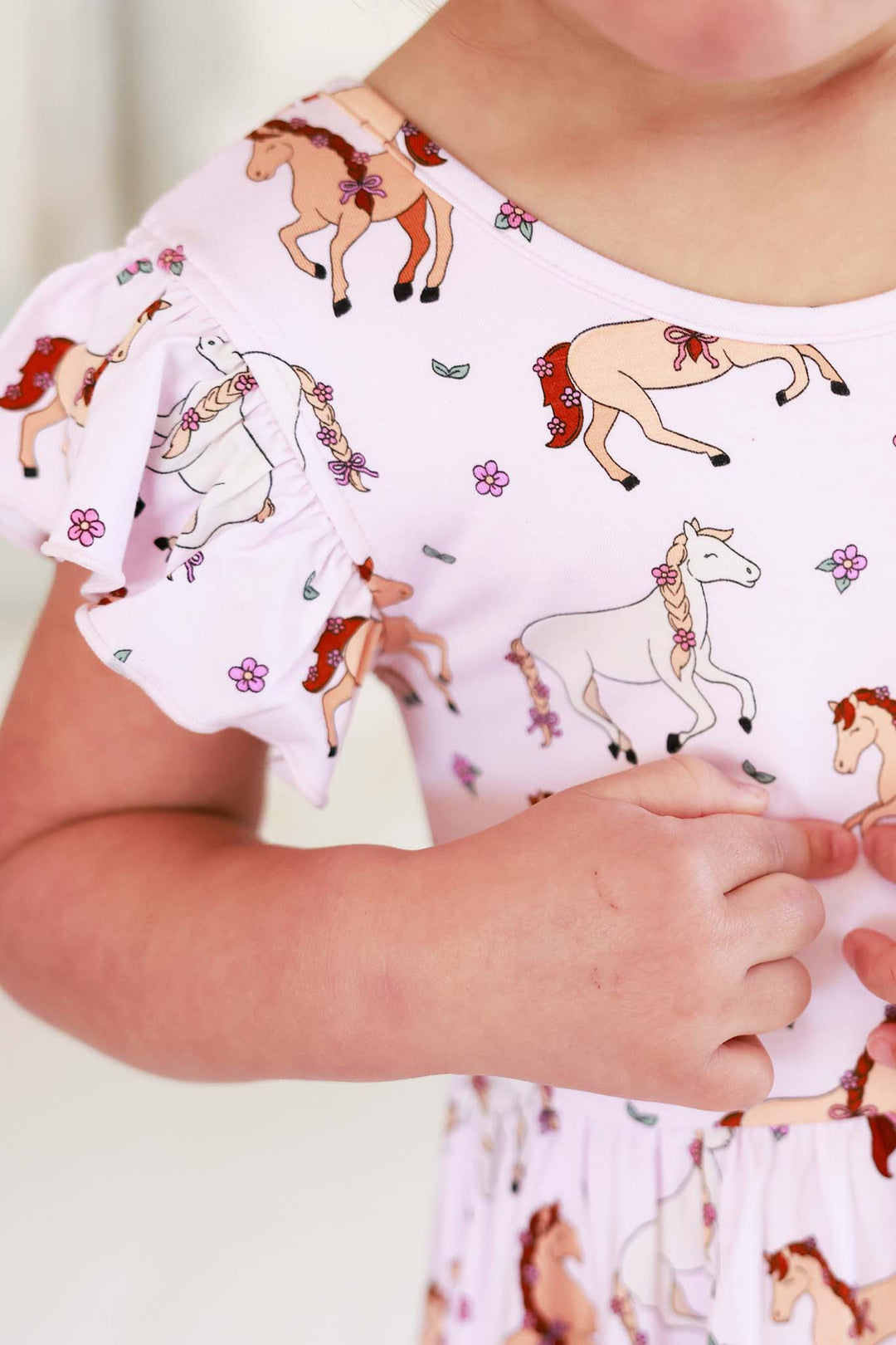 closeup of pink pony club ruffle twirl dress