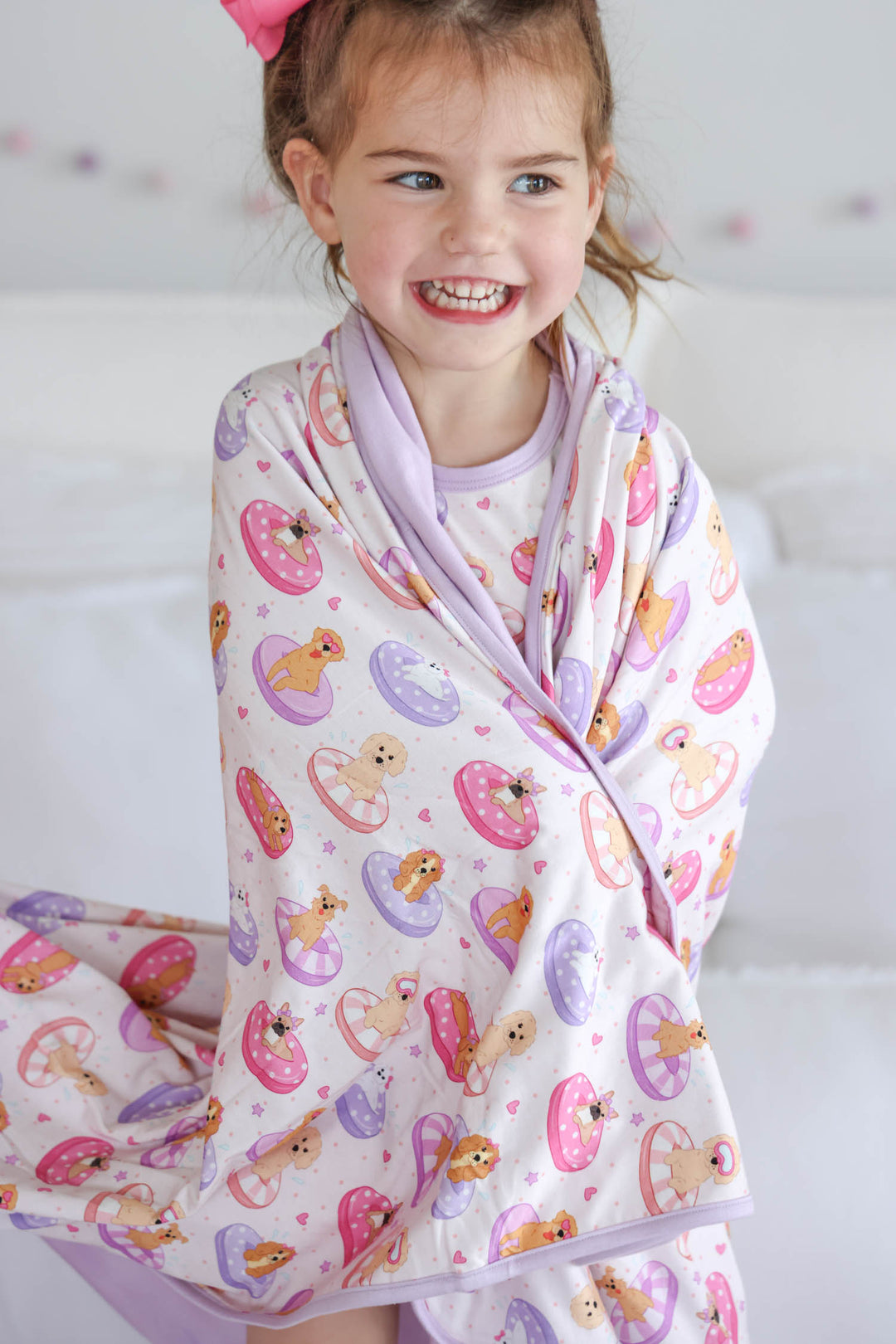 girl with poolside pups double sided bamboo blanket wrapped around her shoulders