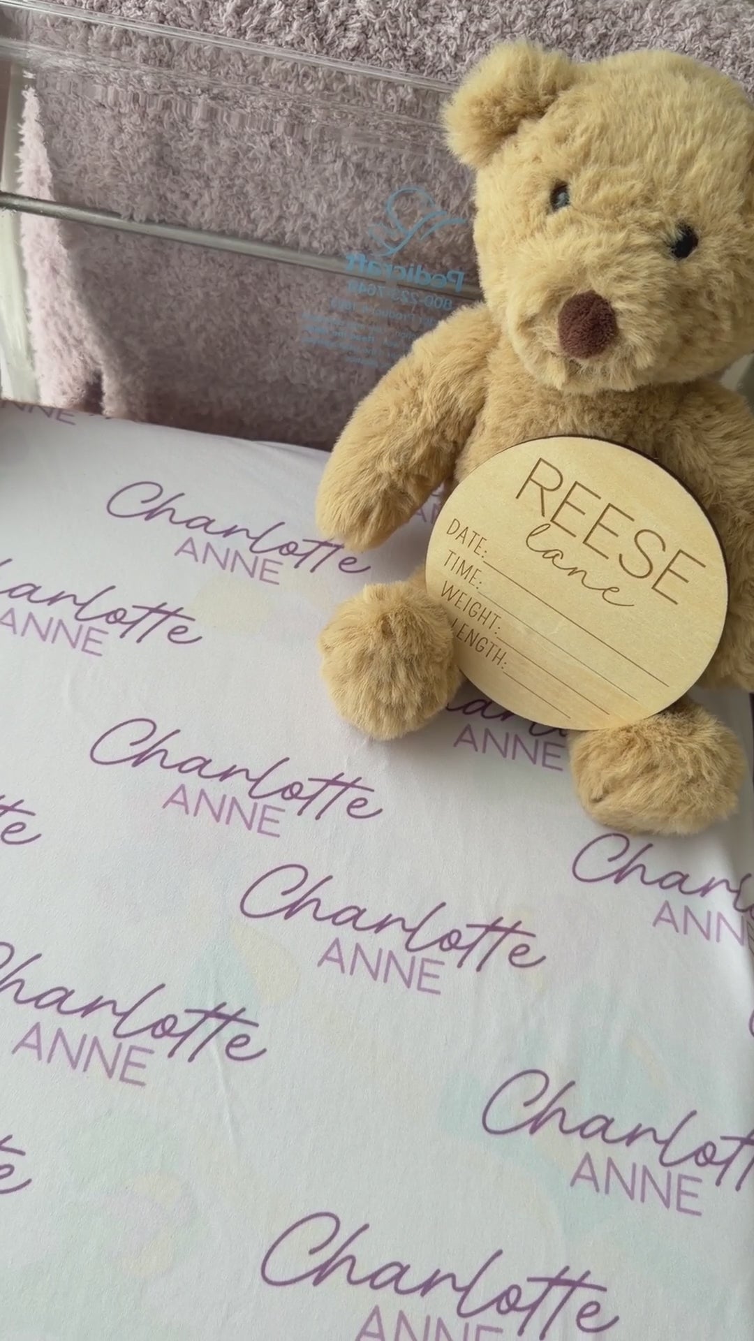 white swaddle blanket with purple name personalization 