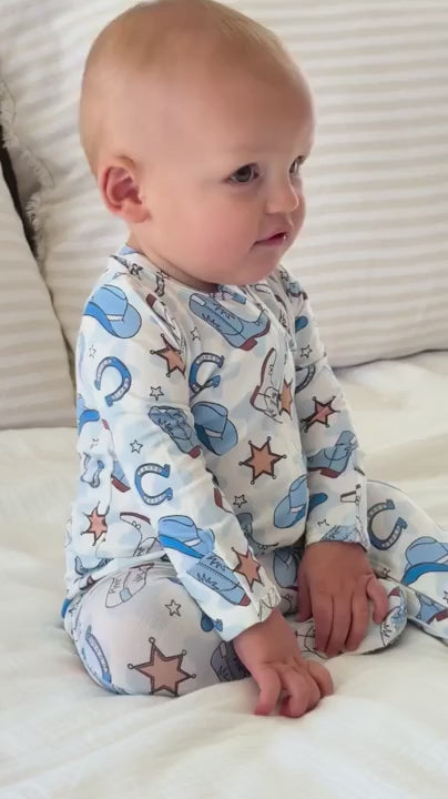 baby boy in blue rodeo footie