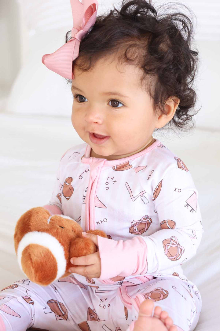 pink football zip romper pajama for girls with matching pink bow