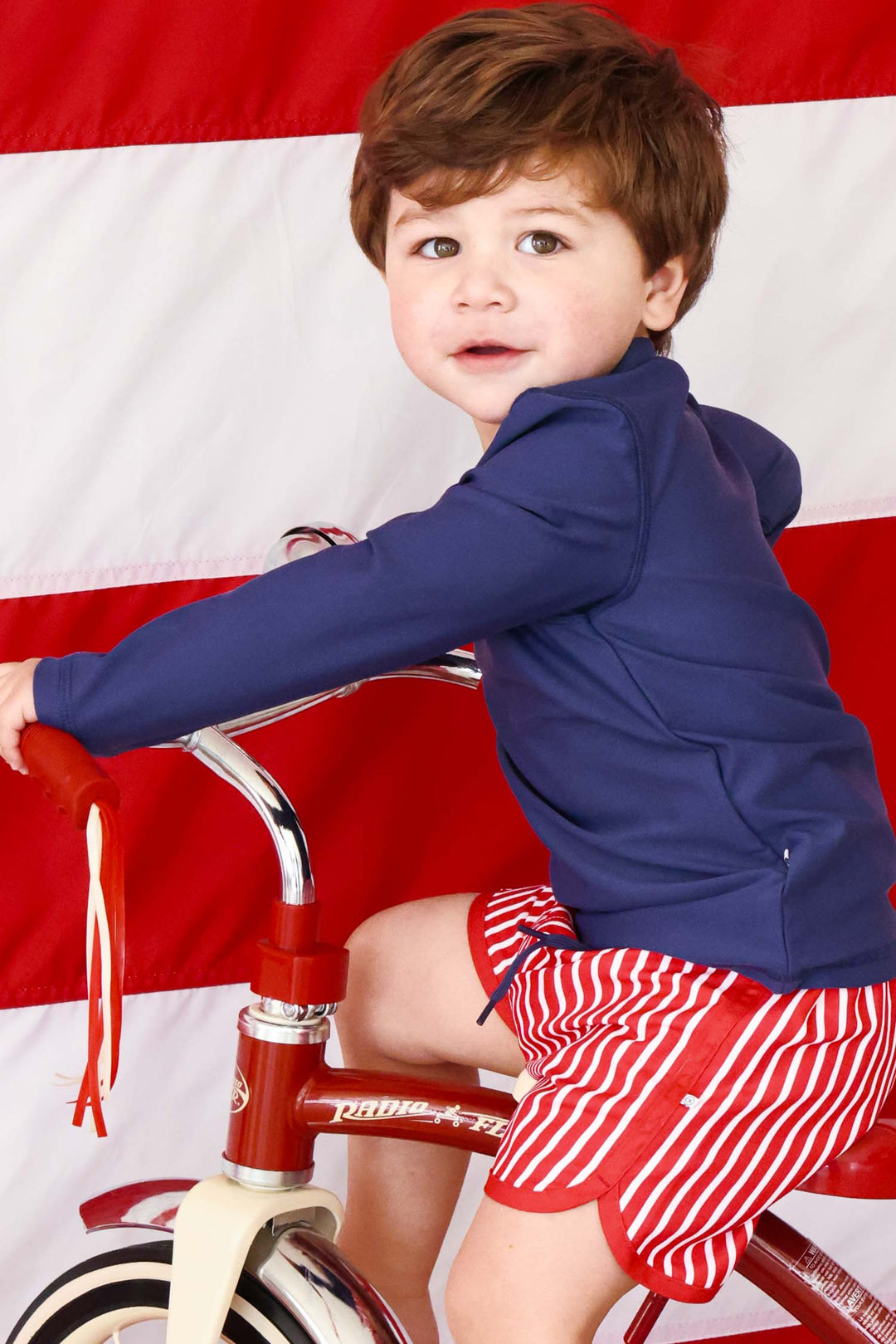 boy riding bike in navy long sleeve rash guard shirt