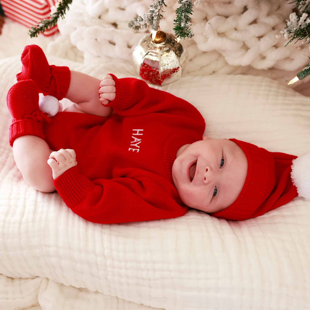 christmas red sweater romper outfit for babies with matching sweater hat and booties with pom poms 