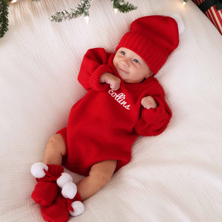 red sweater embroidered with name in white thread and script font for girls with matching beanie 