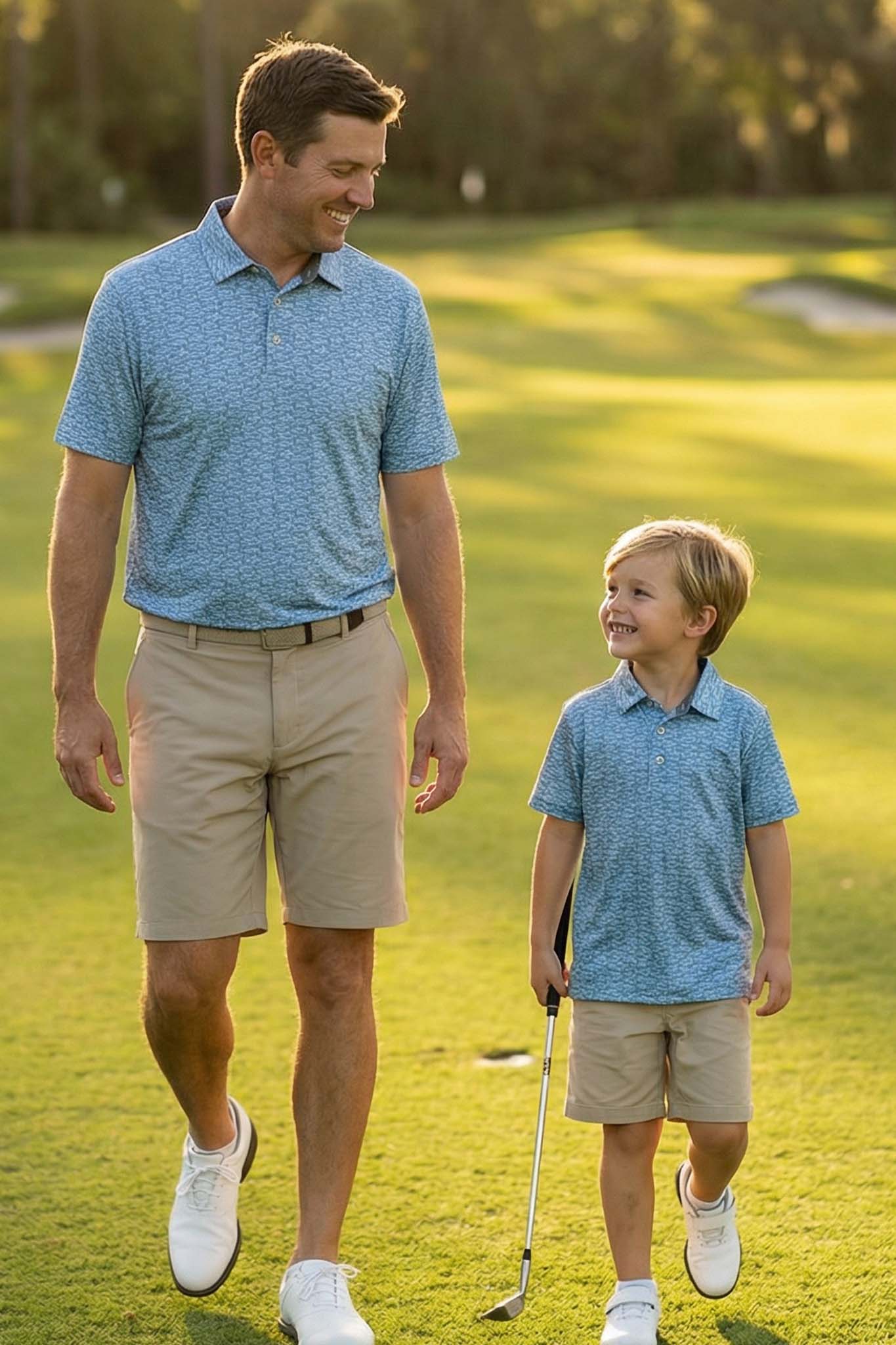 father and son on golf course in matching fishing themed polo shirts 