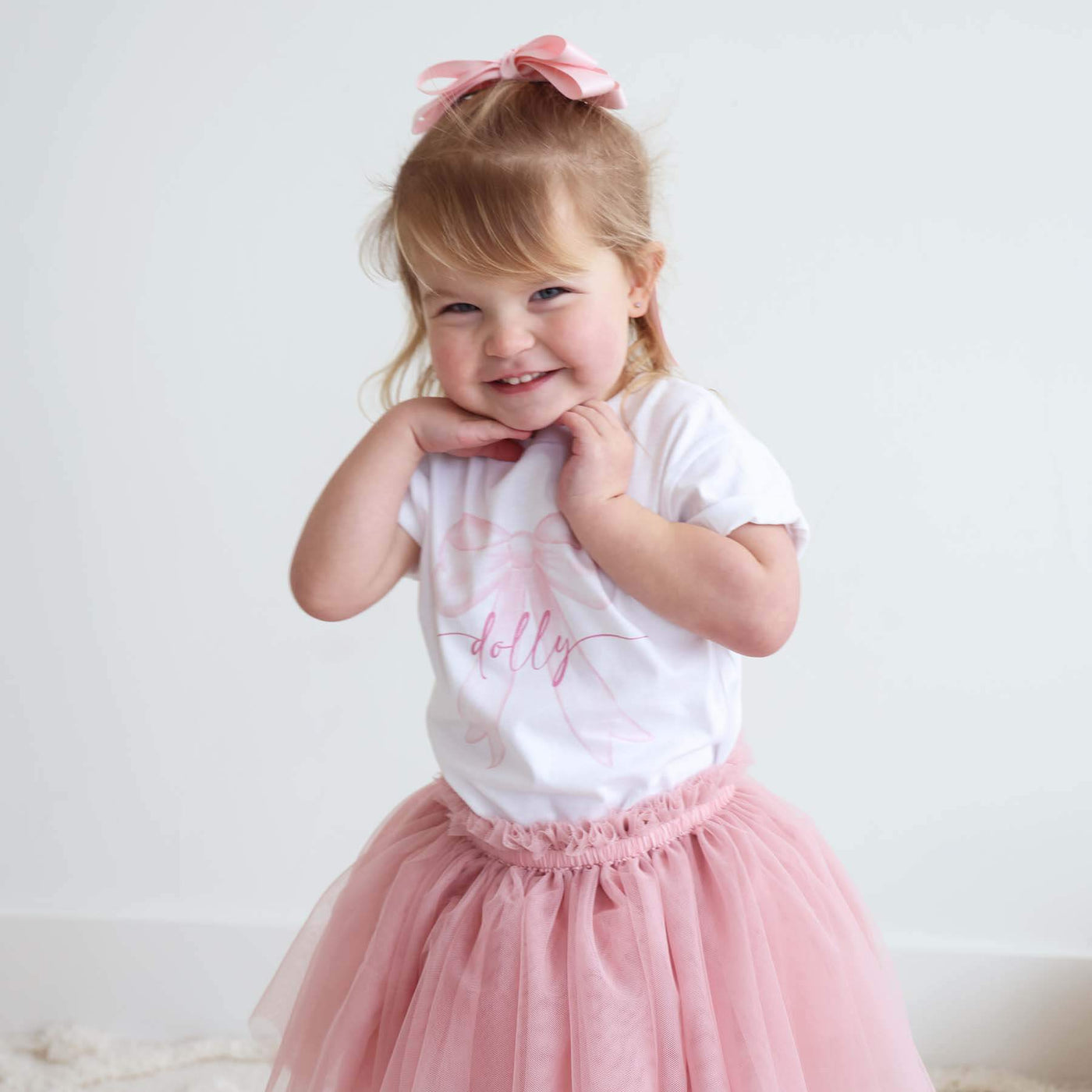kids white graphic tee with pink bow 