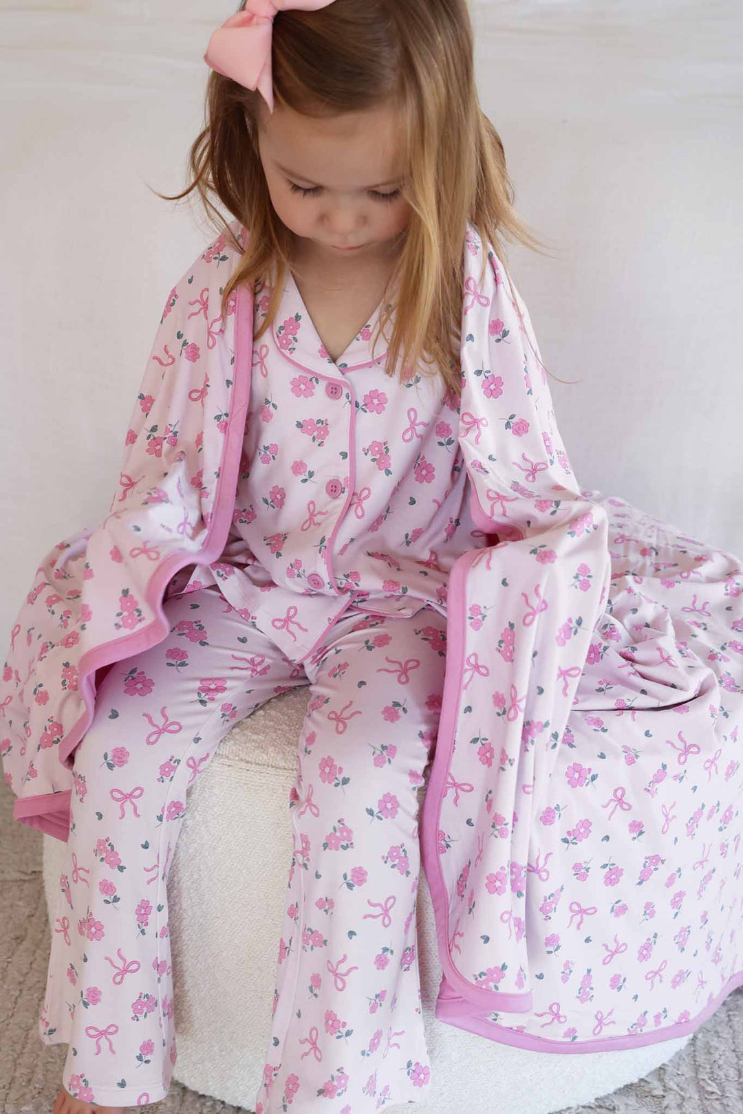 ribbon & roses pink collared lounge set for girls with bamboo blanket around her back