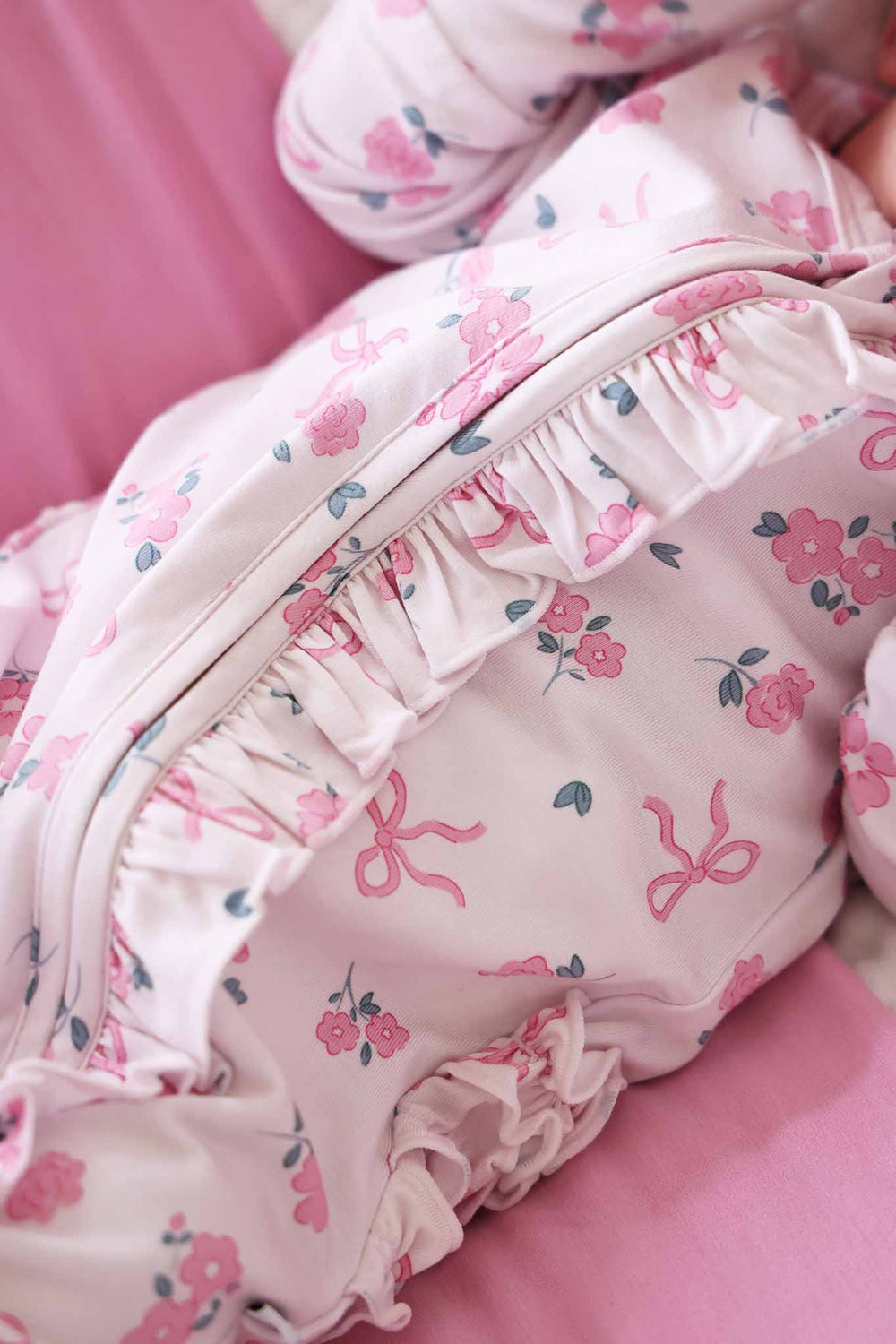 closeup of zipper ruffle for ribbon and roses pink footie for girls 
