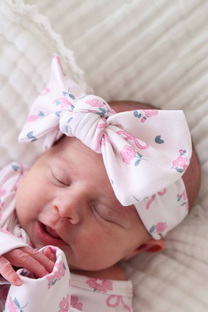 closeup of pink flower and bow knit large bow headwrap for baby girls 