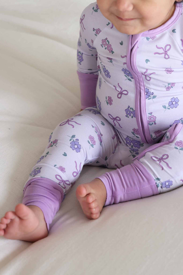 closeup of ribbon and roses purple convertible zip romper 