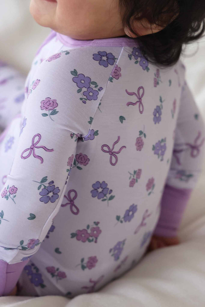 closeup of purple ribbon and roses print 